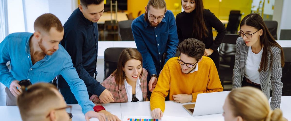 Successful team. Group of young businessmen working and communicating together in creative office. Brainstorming concept. Planning, education, analysis, collaborate work in teamwork.